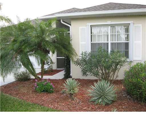 482 Northwest Emilia Way Stuart, FL 34994 - Photo 3 of 25 a front view of a house with garden