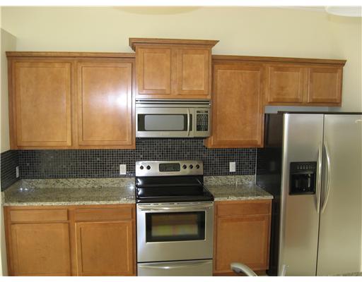 482 Northwest Emilia Way Stuart, FL 34994 - Photo 6 of 25 a kitchen with stainless steel appliances granite countertop a refrigerator and a stove top oven