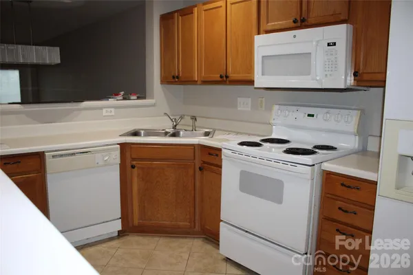 a kitchen with a stove microwave and sink