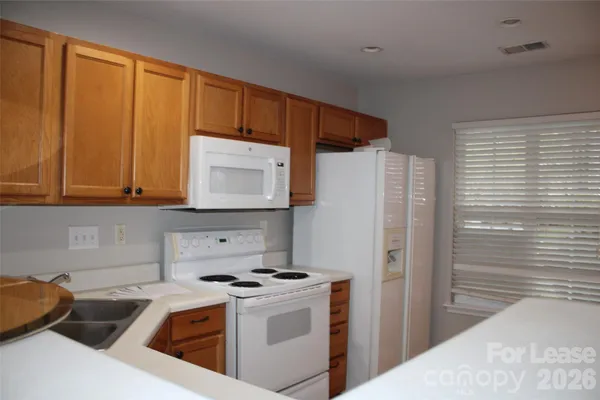 a kitchen with a stove a refrigerator and a sink