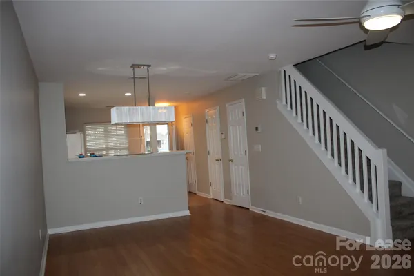 a view of entryway and hall with wooden floor