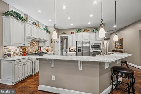 a kitchen with counter top space cabinets and appliances