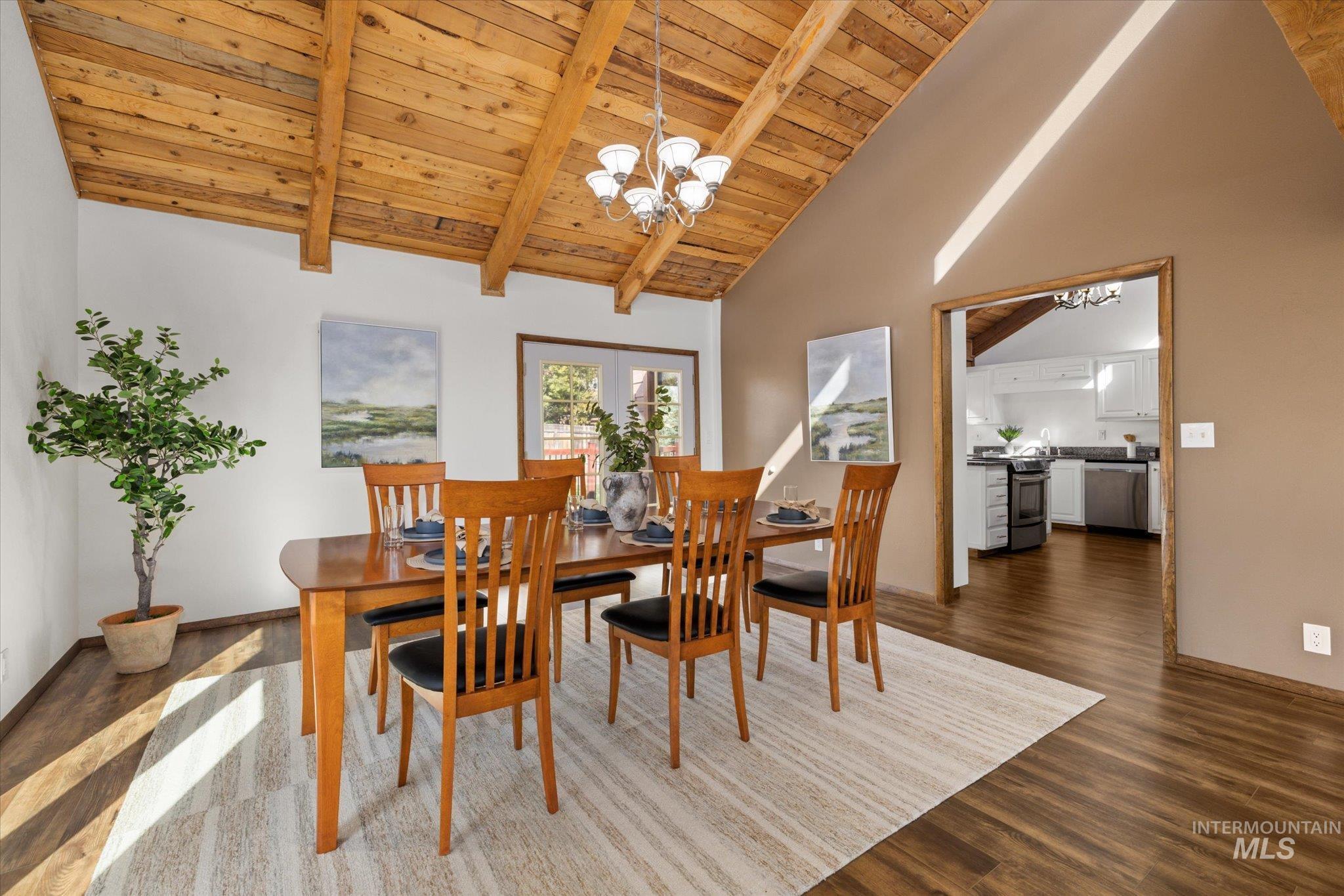 2199 South Ridge Point Way Boise, ID 83712 - Photo 12 of 50 Dining space featuring a chandelier, a wooden ceiling with exposed beams, dark wood-style flooring, and high vaulted ceiling