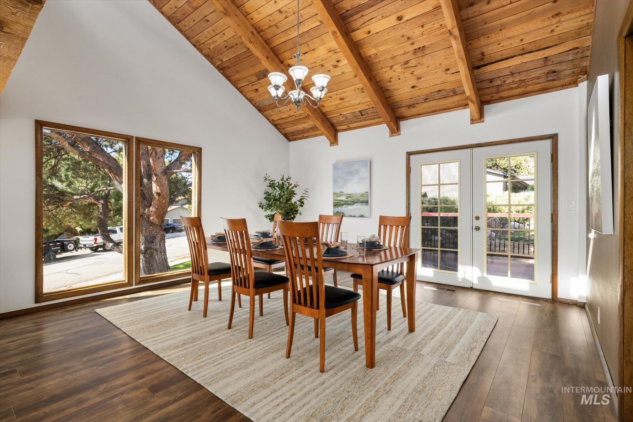 2199 South Ridge Point Way Boise, ID 83712 - Photo 13 of 50 Dining area with a wooden ceiling with exposed beams, high vaulted ceiling, a chandelier, dark wood-type flooring, and french doors
