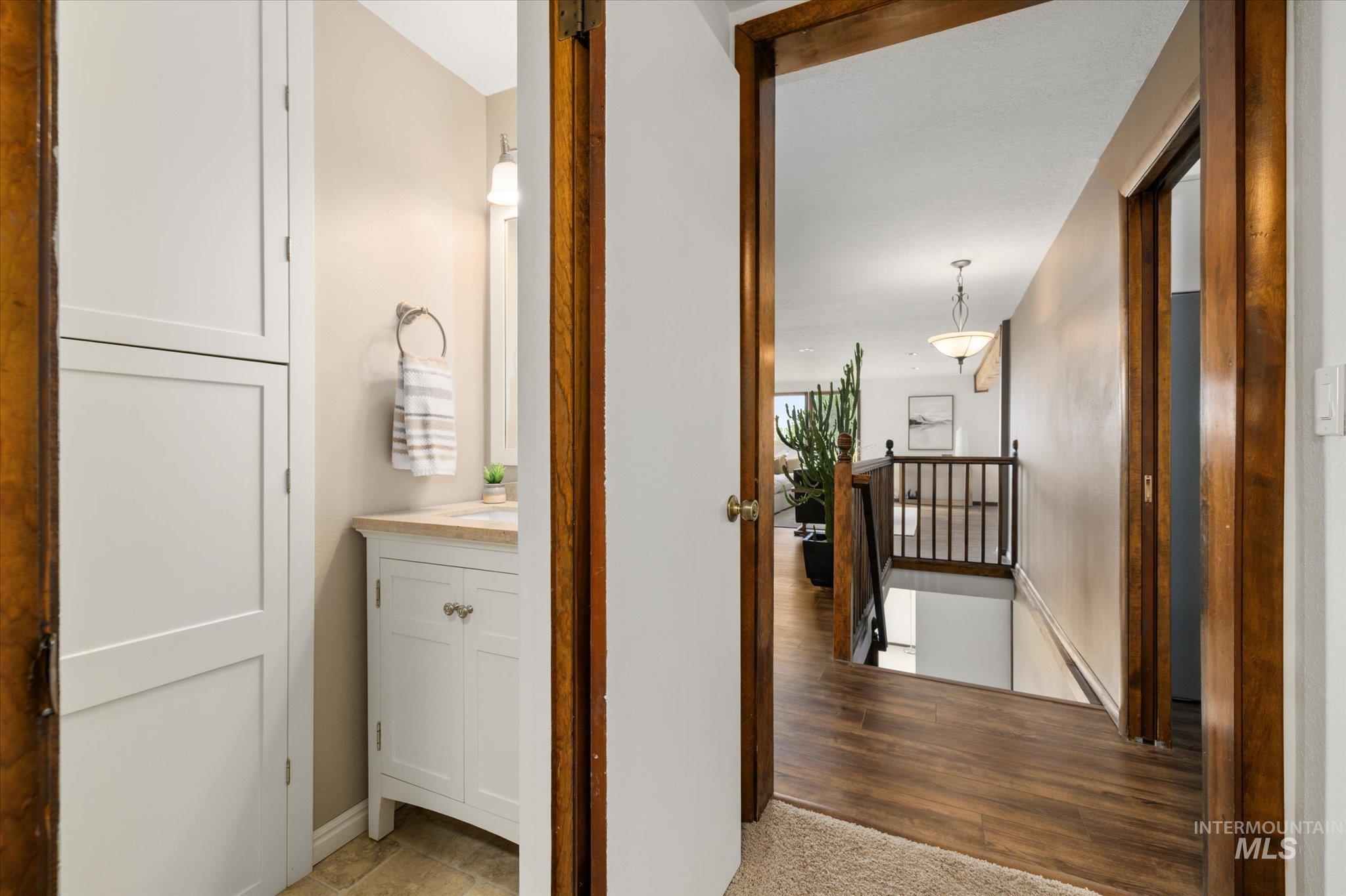 2199 South Ridge Point Way Boise, ID 83712 - Photo 24 of 50 Corridor with an upstairs landing and light wood-style flooring