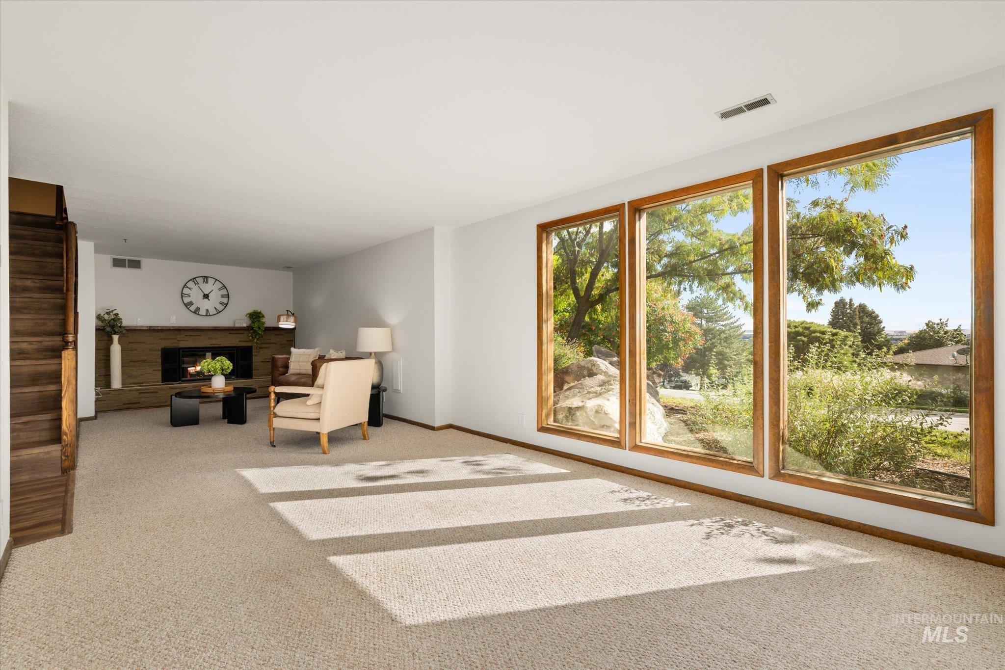 2199 South Ridge Point Way Boise, ID 83712 - Photo 31 of 50 Unfurnished room featuring a lit fireplace and carpet