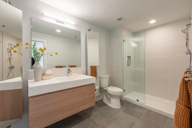 a bathroom with a sink toilet and shower