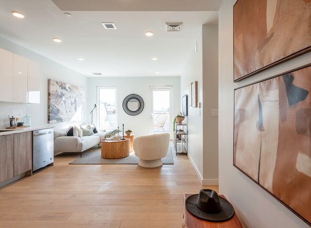 a living room with furniture and a wooden floor