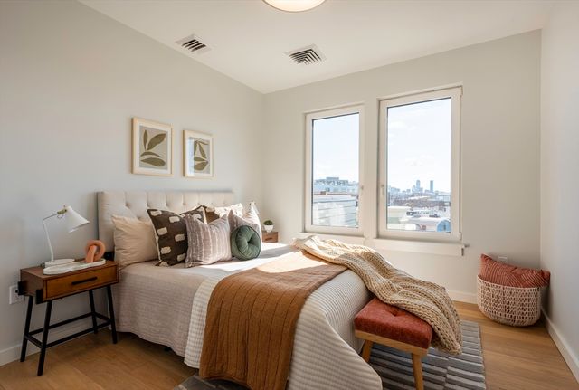 a bedroom with bed and a window