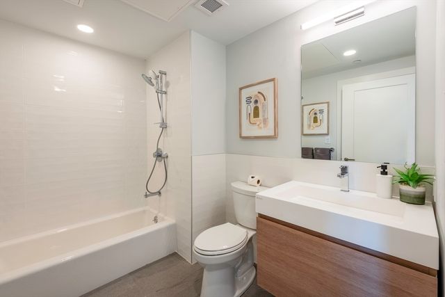 a bathroom with a sink toilet and bathtub
