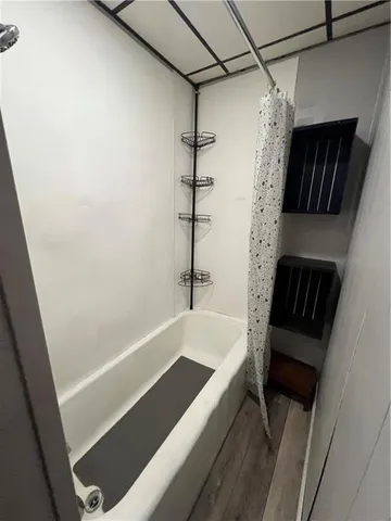 a bathroom with a bathtub and shower
