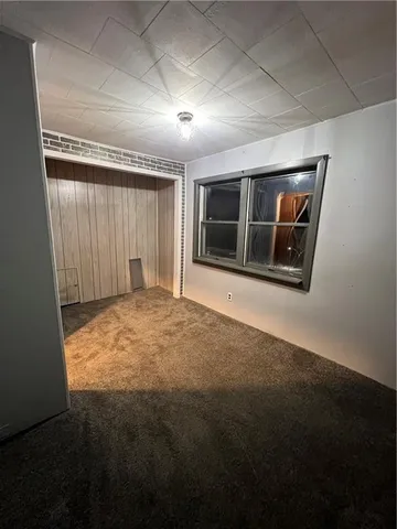 a view of empty room with a fireplace