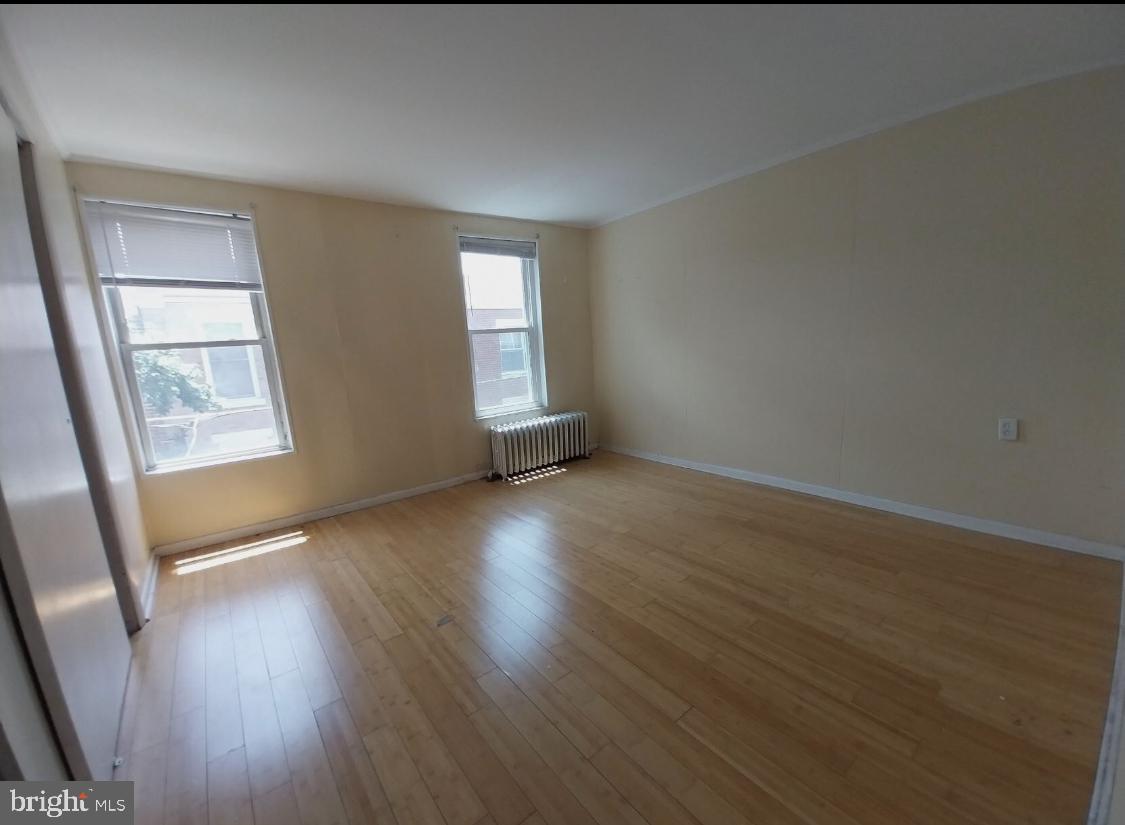 819 Kimball Street Philadelphia, PA 19147 - Photo 13 of 19 an empty room with wooden floor and windows