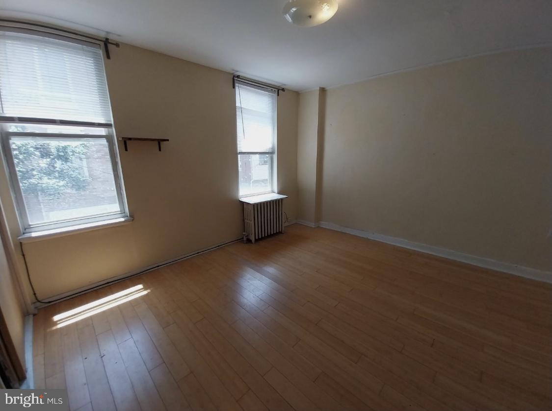 819 Kimball Street Philadelphia, PA 19147 - Photo 15 of 19 an empty room with wooden floor and windows