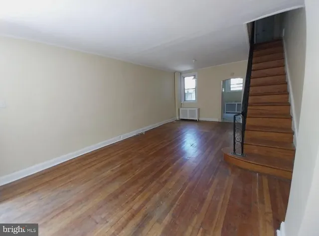 a view of wooden floor and windows in a room
