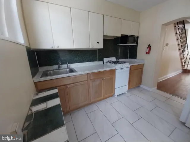 a kitchen with a sink cabinets and appliances