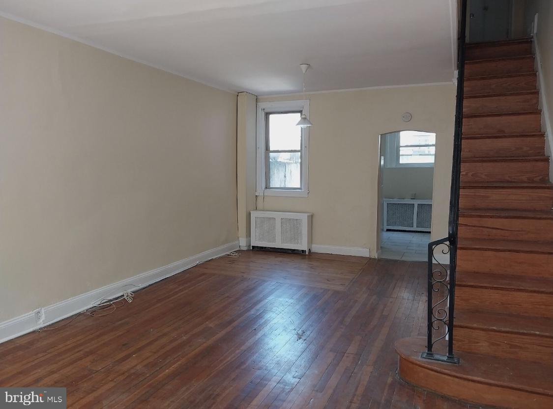 819 Kimball Street Philadelphia, PA 19147 - Photo 8 of 19 a view of an empty room with wooden floor and a window