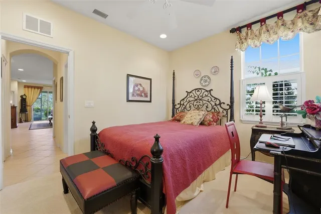 a bedroom with a bed and a table in it