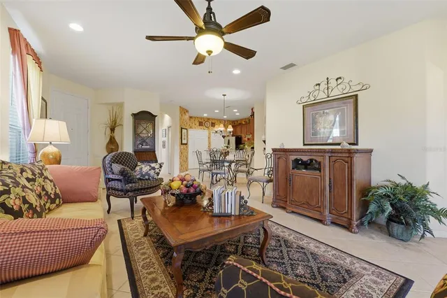 a living room with furniture and a chandelier