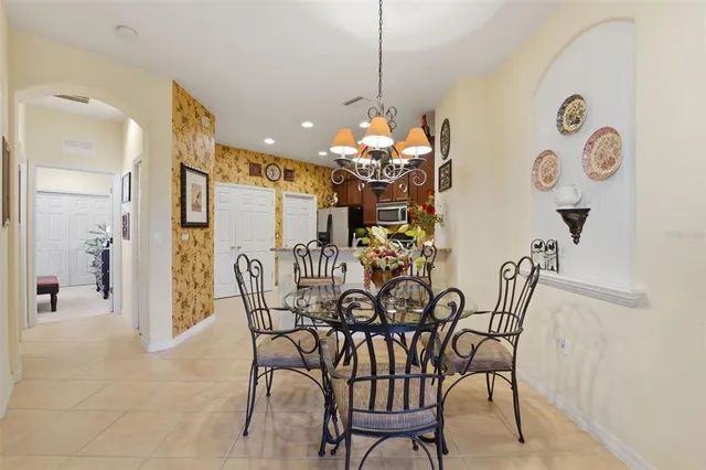 a view of a dining room with furniture and chandelier