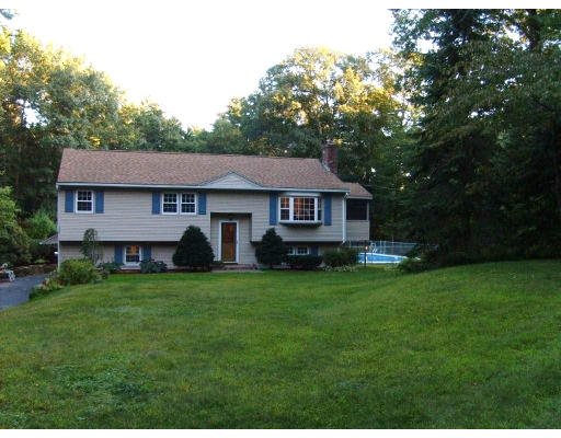 174 Armsby Road Sutton, MA 01590 - Photo 1 of 30 a front view of a house with a garden