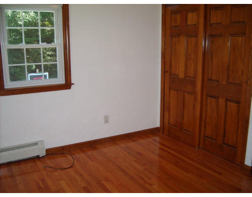174 Armsby Road Sutton, MA 01590 - Photo 12 of 30 an empty room with wooden floor and windows