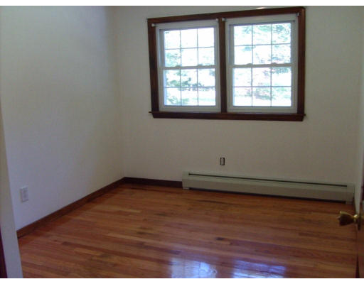 174 Armsby Road Sutton, MA 01590 - Photo 13 of 30 an empty room with wooden floor and windows