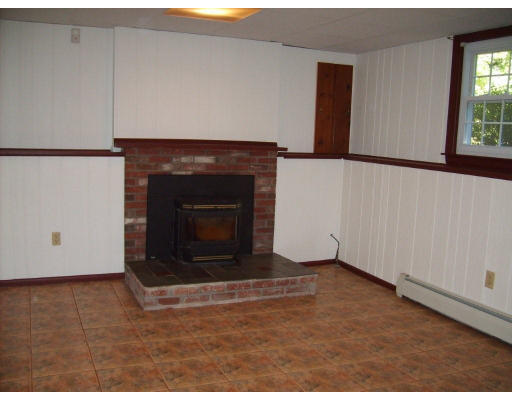 174 Armsby Road Sutton, MA 01590 - Photo 15 of 30 a living room with a fireplace
