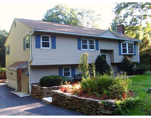 174 Armsby Road Sutton, MA 01590 - Photo 2 of 30 a front view of a house with a yard and potted plants