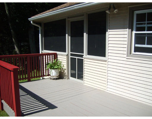 174 Armsby Road Sutton, MA 01590 - Photo 21 of 30 a view of a balcony with a floor to ceiling window and wooden fence