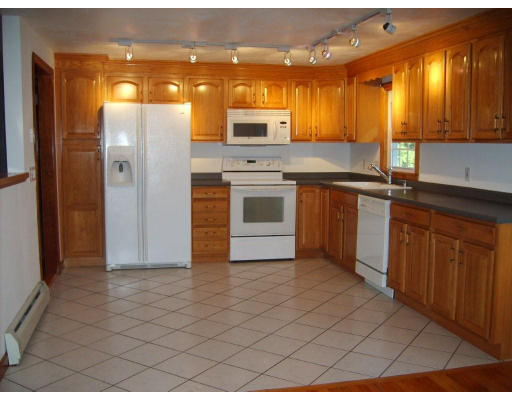 174 Armsby Road Sutton, MA 01590 - Photo 5 of 30 a kitchen with stainless steel appliances granite countertop a stove a sink and a microwave