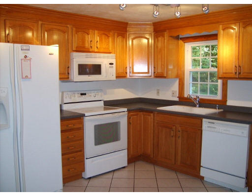174 Armsby Road Sutton, MA 01590 - Photo 6 of 30 a kitchen with stainless steel appliances granite countertop a stove a sink and a refrigerator
