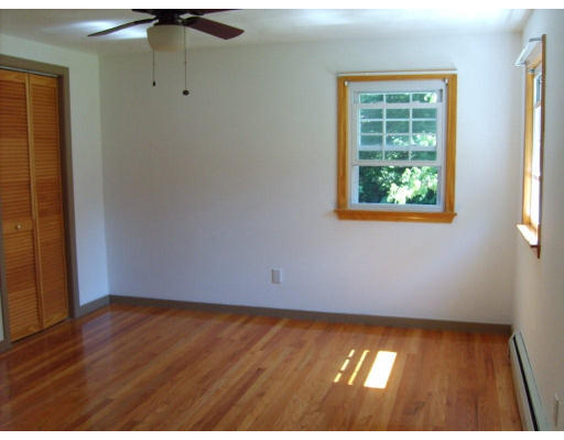 174 Armsby Road Sutton, MA 01590 - Photo 10 of 30 an empty room with wooden floor and windows