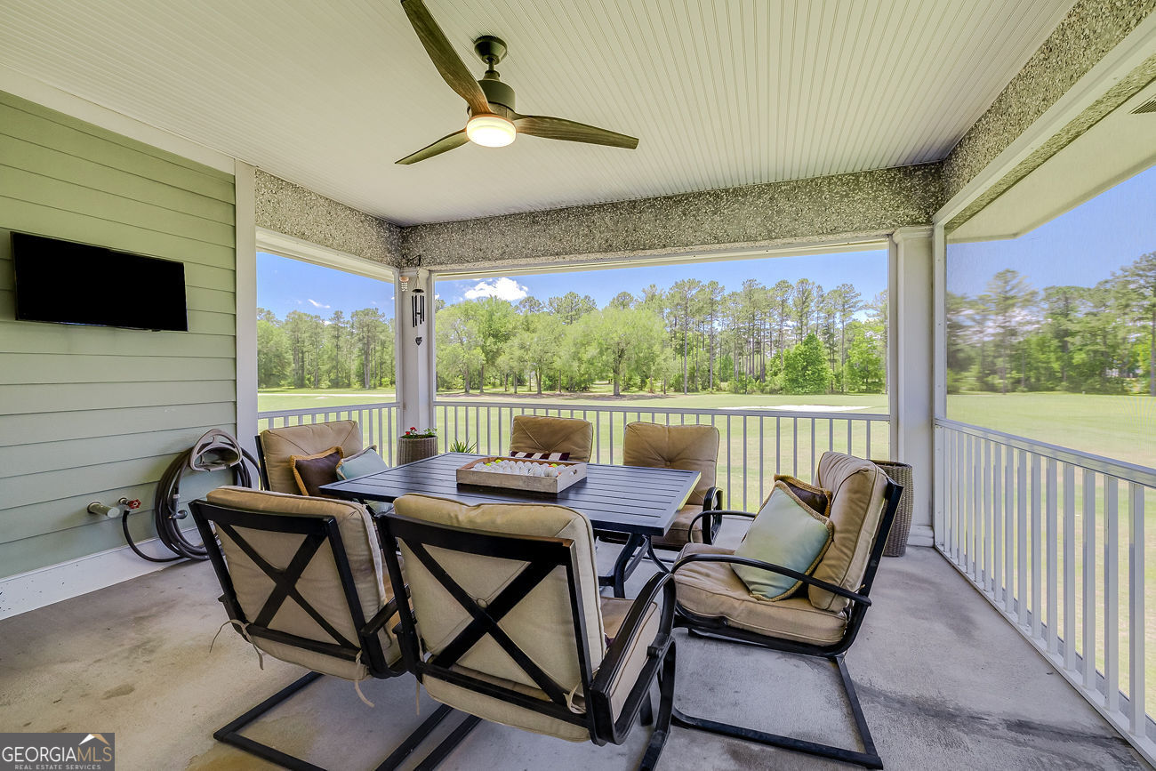 7272 Shellman Bluff Road Northeast, Unit 18 Townsend, GA 31331 - Photo 4 of 31 a living room with furniture and a floor to ceiling window