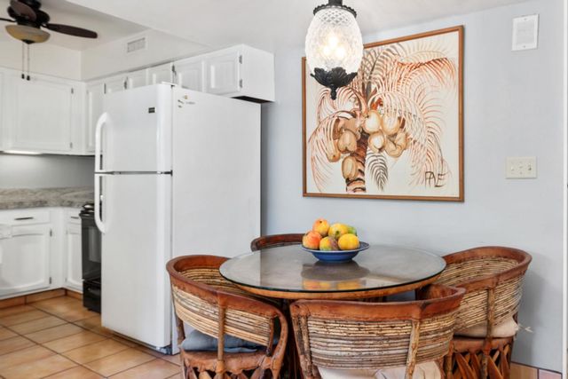 a white kitchen with a table and chairs in it