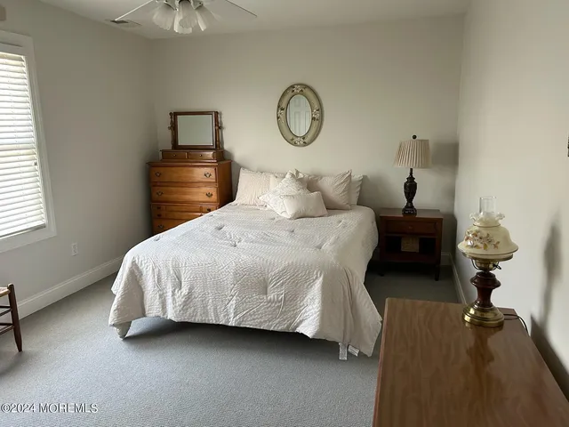 a bedroom with bed and a chandelier
