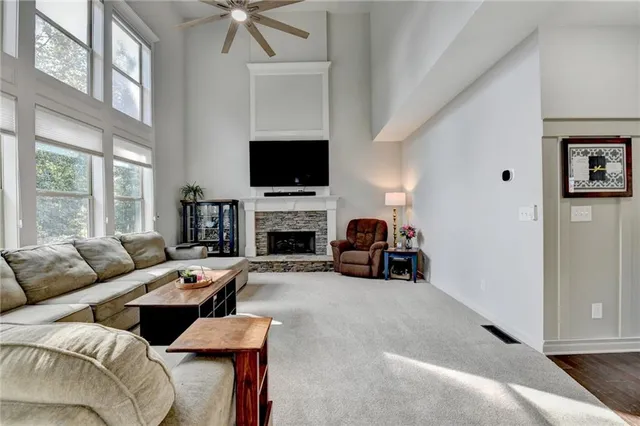 a kitchen with granite countertop a stove a sink and a microwave