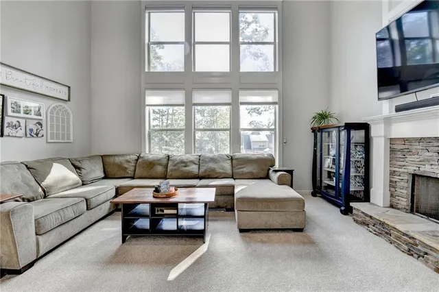 a kitchen with stainless steel appliances kitchen island granite countertop a stove a sink a dining table and chairs with wooden floor