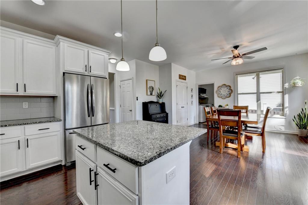 533 Widgeon Way Jefferson, GA 30549 - Photo 25 of 101 a kitchen with stainless steel appliances granite countertop a stove refrigerator and white cabinets