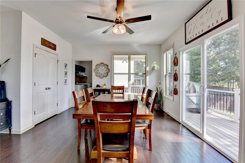 533 Widgeon Way Jefferson, GA 30549 - Photo 32 of 101 a dining room with furniture a chandelier and wooden floor