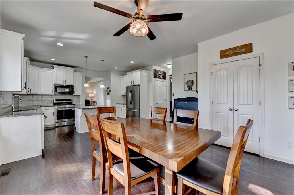 533 Widgeon Way Jefferson, GA 30549 - Photo 34 of 101 a view of a dining room with furniture and wooden floor
