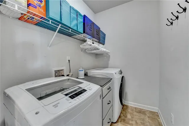 a view of walk in closet with clothes
