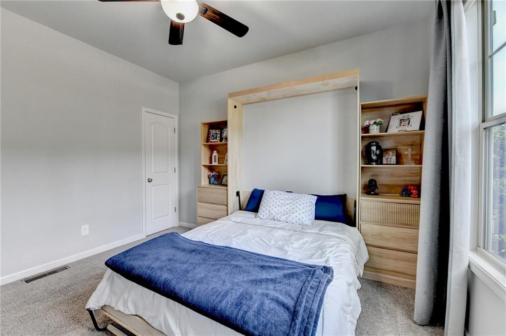 533 Widgeon Way Jefferson, GA 30549 - Photo 46 of 101 a bedroom with a large bed and a chandelier