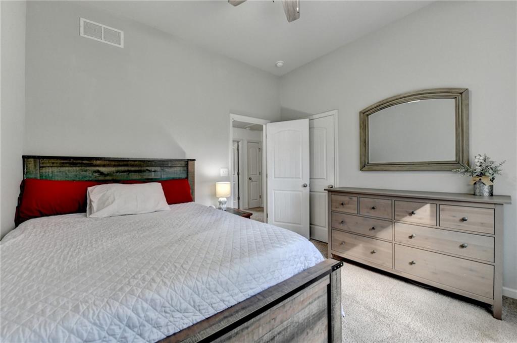 533 Widgeon Way Jefferson, GA 30549 - Photo 60 of 101 a bedroom with a large bed and a dresser