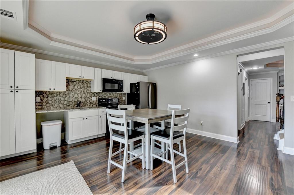 533 Widgeon Way Jefferson, GA 30549 - Photo 83 of 101 a kitchen with stainless steel appliances a dining table chairs and granite counter tops