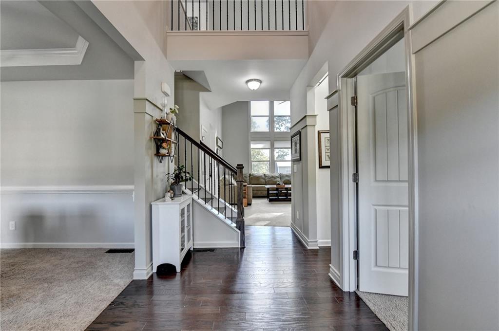 533 Widgeon Way Jefferson, GA 30549 - Photo 9 of 101 a hallway with wooden floor windows and entryway