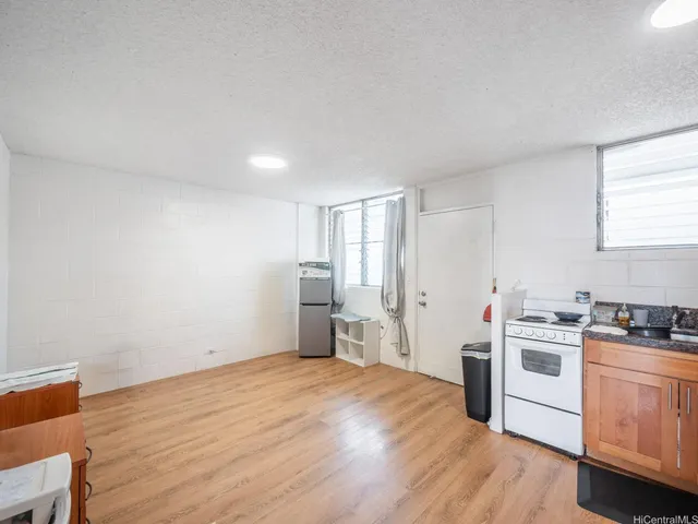 a kitchen with a stove a sink and a refrigerator