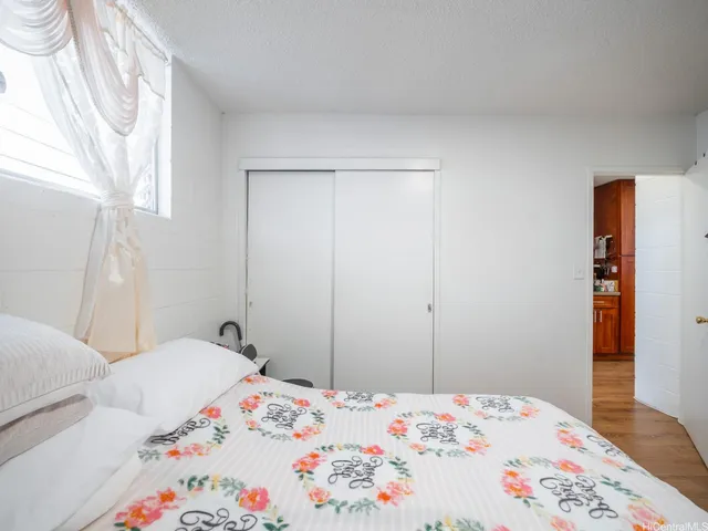 a bedroom with a bed and a dresser in it