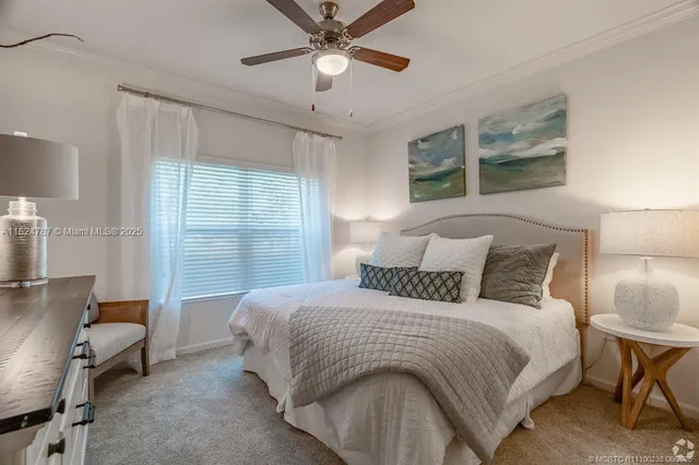 a bedroom with a large bed and a window