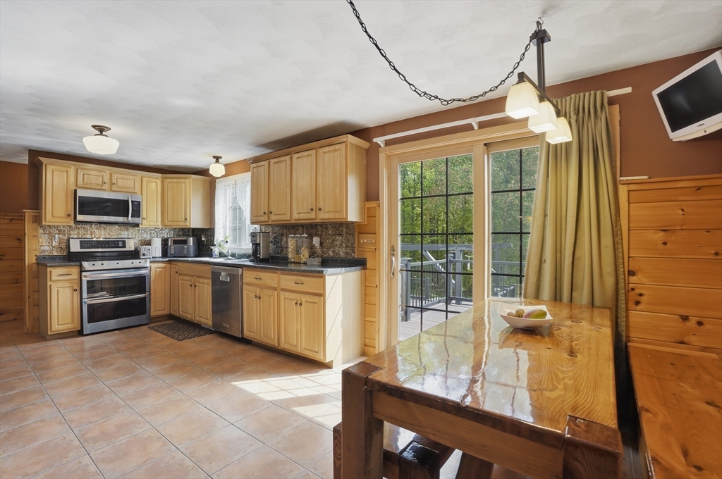 160 Gray Road Templeton, MA 01468 - Photo 12 of 42 a kitchen with granite countertop a stove a sink and a refrigerator